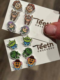 Dental earrings featuring toy tooth designs from Teeth Obsessed, displayed on silver hooks with a playful, realistic tooth appearance.