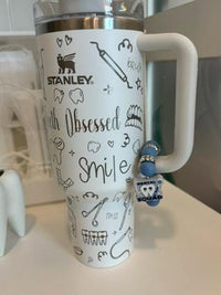 Teeth Obsessed dental charms for Stanley Cups, colorful cup toppers with tooth-themed designs on a tumbler.