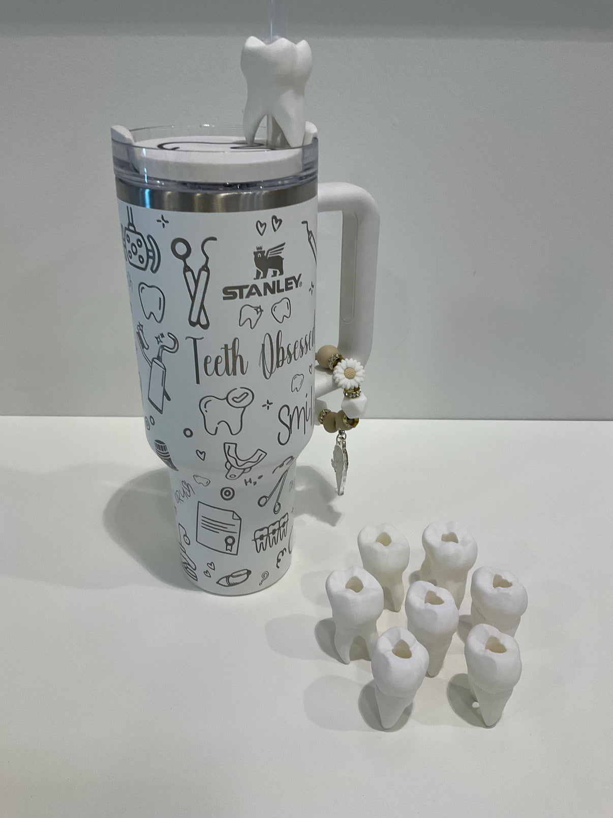 Teeth Obsessed molar tooth straw topper placed on a clear tumbler, featuring detailed molar tooth design for dental-themed drinks.