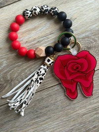 Teeth Obsessed Dental Rose keychain featuring a pink rose-shaped dental accessory on a silver keyring.