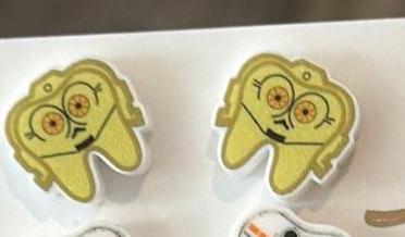 Dental Wars earrings by Teeth Obsessed featuring detailed dental-themed designs on silver-tone earrings.