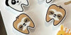 Set of four dental earrings featuring panda, sloth, giraffe, and zebra designs by Teeth Obsessed on a plain background.