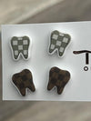 Check Tooth Dental Earrings by Teeth Obsessed featuring realistic tooth-shaped earrings on display.