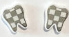 Silver check tooth dental earrings by Teeth Obsessed featuring realistic tooth and check mark design for a fun, quirky accessory.