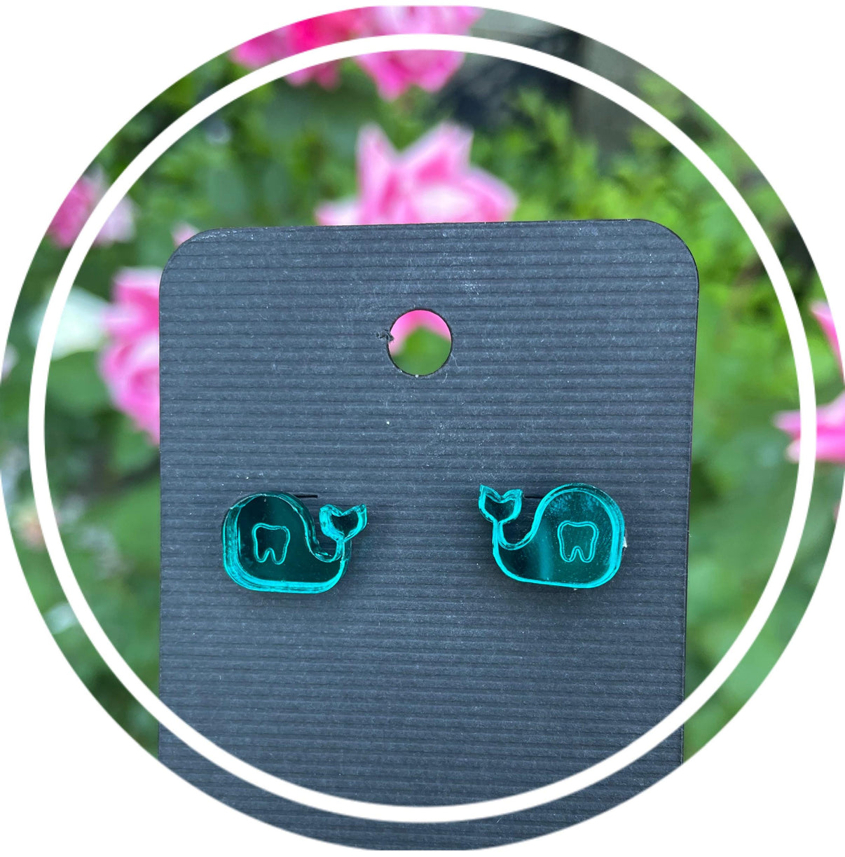 Whale-shaped dental earrings by Teeth Obsessed featuring silver-tone whale design on a white background.