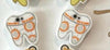 Teeth Obsessed Dental Wars earrings featuring small tooth-shaped charms hanging from silver hooks.
