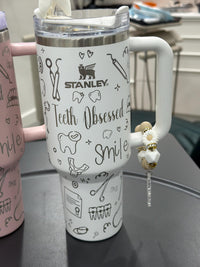 Teeth Obsessed tumbler with tooth-shaped toppers, featuring colorful design and durable cup for everyday use.