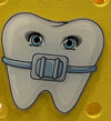 Gold Tooth Bogg Bag Charm featuring orthodontic tooth, nerves, denture, and tooth design from Teeth Obsessed charms and pins collection.