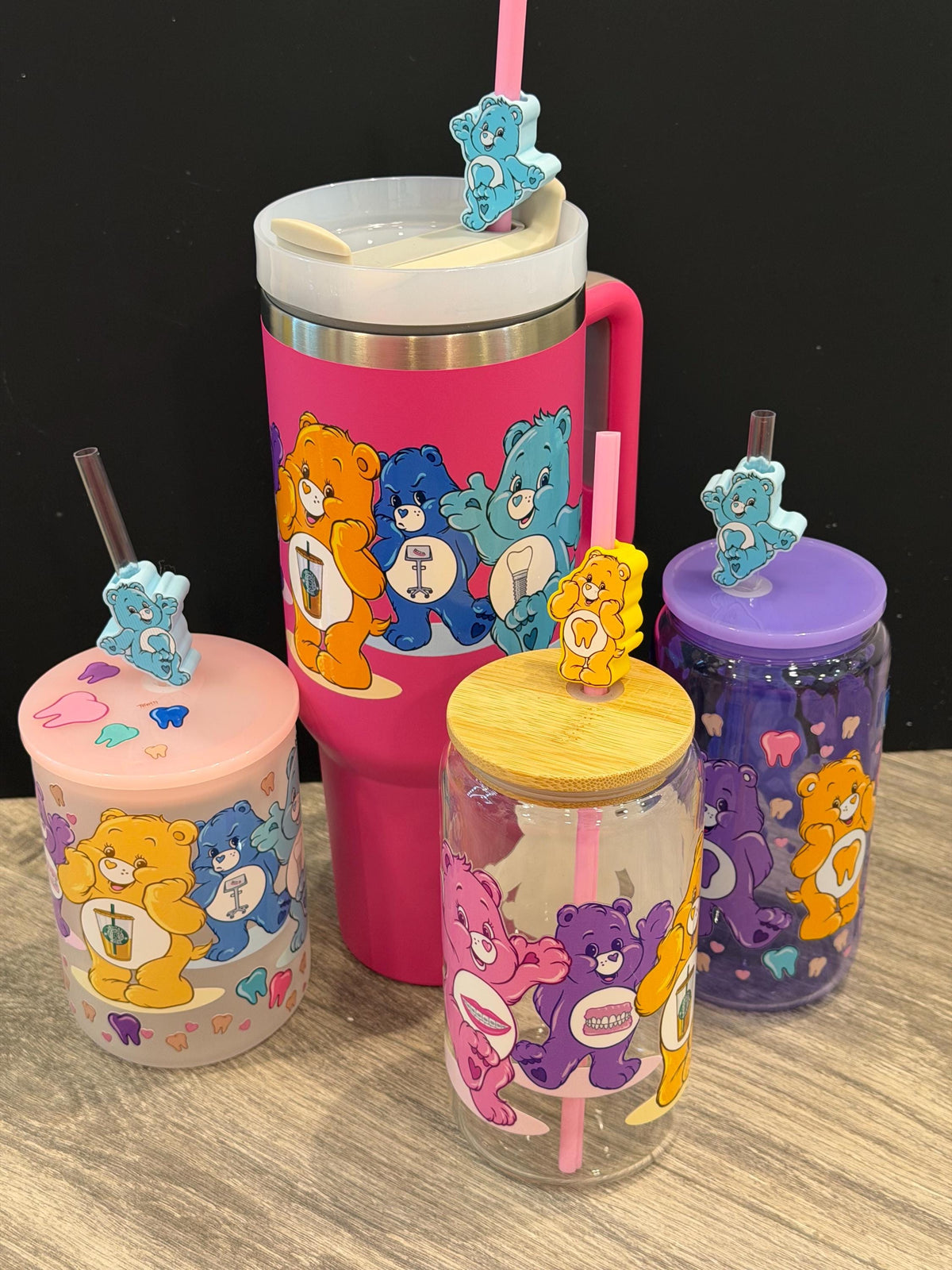 Pink and yellow Dental Bear Drinkwear cups and tumblers by Teeth Obsessed featuring playful bear designs and dental-themed toppers.