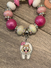 Teeth Obsessed rabbit sponge drinkware charm on a cup or tumbler, featuring a playful, colorful design for cups and toppers.