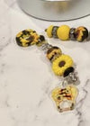 Teeth Obsessed sunflower dental tumbler with charm, featuring colorful sunflower design on reusable drinkware.