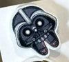 Teeth Obsessed Space Wars Dental Earrings featuring spaceship and tooth designs on silver hooks.