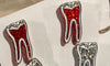 Black RCT Dental Earrings by Teeth Obsessed featuring realistic tooth designs, perfect for dental enthusiasts.