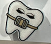 Blue orthodontic tooth earrings by Teeth Obsessed, featuring dental-themed jewelry with realistic tooth designs.