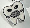 Blue orthodontic tooth earrings by Teeth Obsessed, dental-themed jewelry featuring realistic tooth designs.