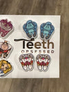 Teeth Obsessed Wonderland Dental Earrings featuring colorful cat-shaped dental designs on silver hoops.