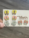 Dental Sea Teeth Earrings by Teeth Obsessed featuring crab-shaped dental earrings with ocean-inspired design.