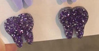 Dark purple dental earrings by Teeth Obsessed featuring tooth-shaped design, perfect for dental-themed jewelry enthusiasts.