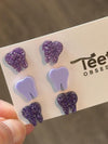 Dark purple Teeth Obsessed dental earrings featuring tooth-shaped designs, stylish jewelry for dental enthusiasts.
