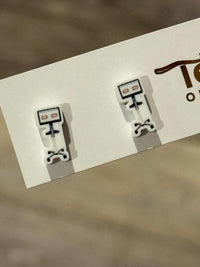 Teeth Obsessed digital scanning dental earrings featuring realistic tooth design on shiny metal studs.