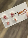 Teeth Obsessed dental earrings shaped like root canal nerves, featuring detailed, realistic tooth and nerve design for dental enthusiasts.