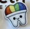 Rainbow glitter tooth earrings by Teeth Obsessed featuring colorful dental-themed jewelry with sparkling rainbow accents.