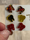 Red and gold dental earrings by Teeth Obsessed featuring tooth-shaped charms with vibrant red and gold detailing.