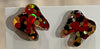 Red and gold dental earrings by Teeth Obsessed featuring tooth-shaped charms with vibrant red and gold accents.