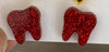 Red glitter dental earrings by Teeth Obsessed featuring small tooth-shaped charms with a vibrant red finish.