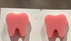 Pink glitter tooth earrings from Teeth Obsessed, featuring vibrant pink dental-themed jewelry with sparkling glitter accents.