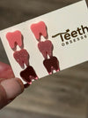 Pink glitter dental earrings by Teeth Obsessed featuring solid pink tooth-shaped design for a fun, playful jewelry statement.