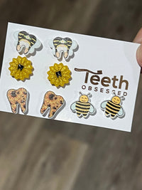 Teeth Obsessed sunflower tooth earrings, dental assistant gift, gold-tone dental jewelry with sunflower and tooth design.