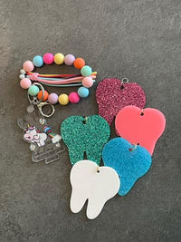 Dark green Dental Unicorn Keychain from Teeth Obsessed featuring a cute unicorn design for dental enthusiasts.