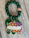 Set of Teeth Obsessed dental keychains featuring teal, pink, green, and dark green denture-shaped designs.