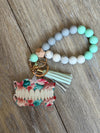 Teeth Obsessed denture dental keychains in teal, pink, green, and dark green with detailed tooth designs.