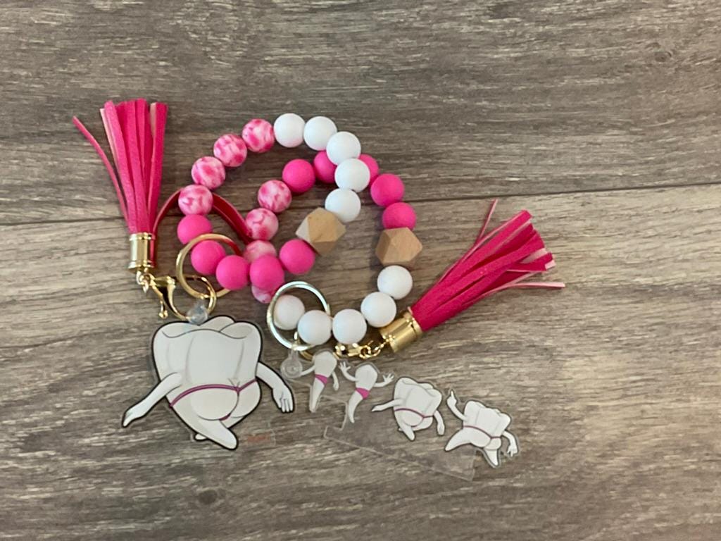 Mrs Flossy and Friends Dental Keychain by Teeth Obsessed featuring flossing character with tooth design, colorful and playful.