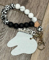 Pink handmade acrylic cow dental keychain featuring a tooth design, by Teeth Obsessed, perfect for dental enthusiasts.