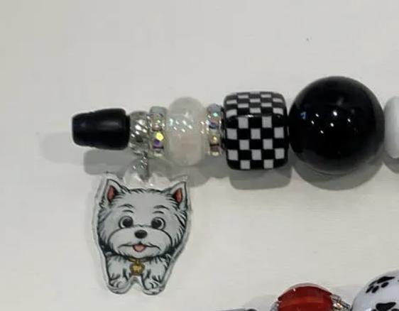 White dog-shaped Bubble Tooth Pens from Teeth Obsessed, dental pens and holders with playful black and white dog design.