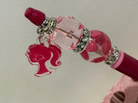 Pink dental team charm with loupes on Teeth Obsessed dental pens and holders, featuring detailed dental professional figures.