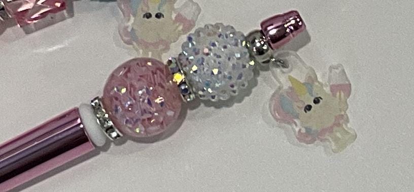 Pink and white Tooth Fairy Unicorn Bubble Pens from Teeth Obsessed, featuring playful unicorn and tooth-themed designs.