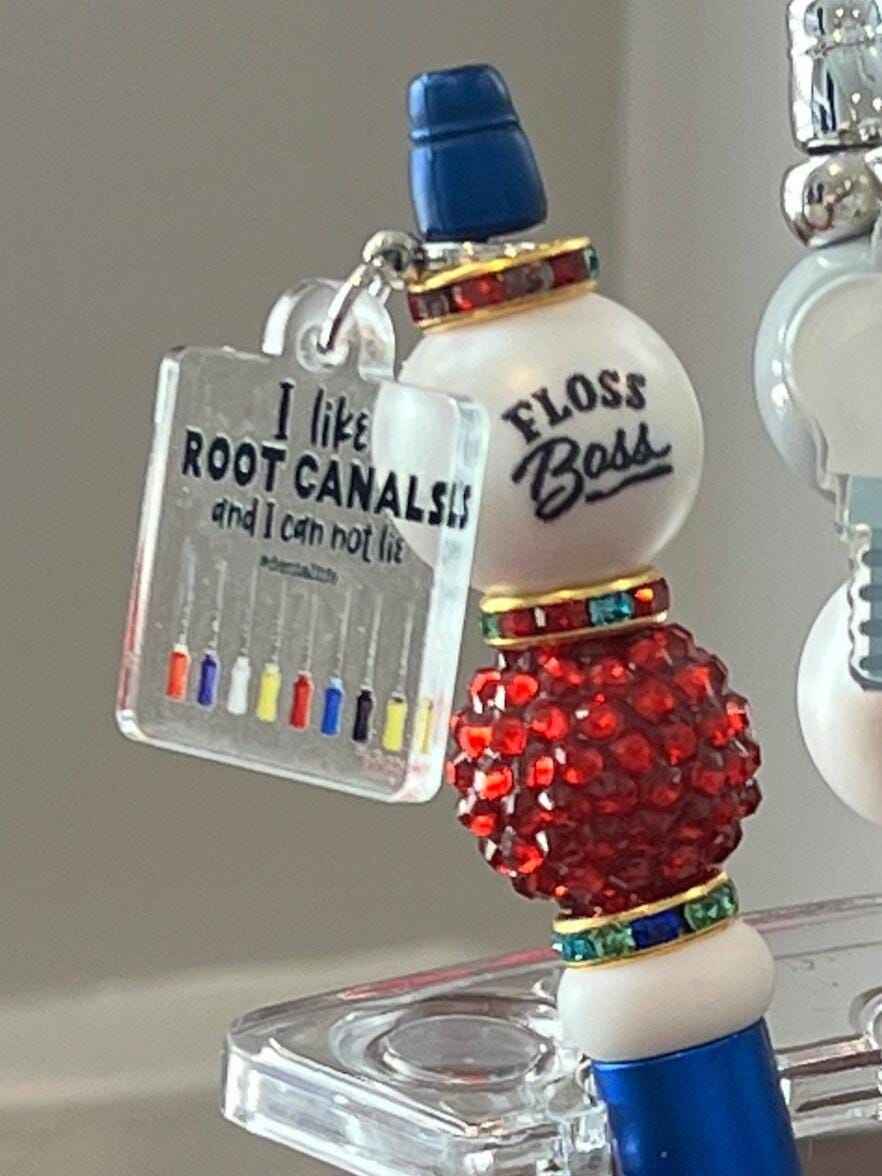 Teeth Obsessed dental bubble pens and holders featuring colorful, playful designs inspired by root canal dental themes.
