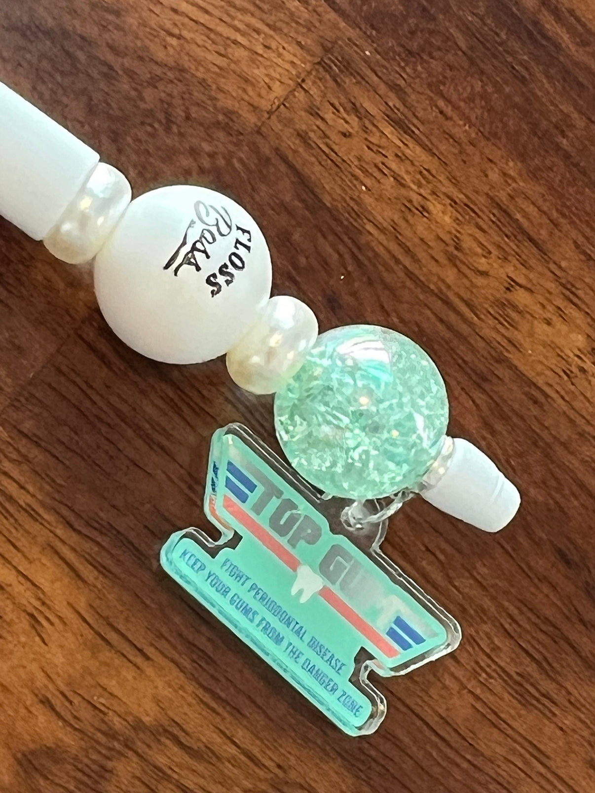 Teeth Obsessed dental pens and holders featuring sunflower, denture, and implant-themed designs for oral care.