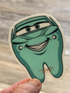 Blue car character dental sticker from Teeth Obsessed, designed as a fun dental-themed tooth sticker for kids.