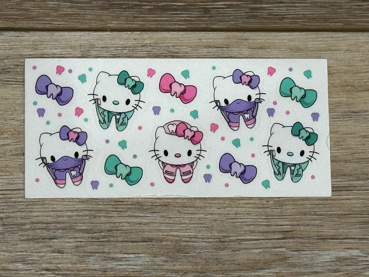 Kitty Tooth Sticker Sheet with 5 tiny dental stickers from Teeth Obsessed, featuring cute cat-themed tooth designs.