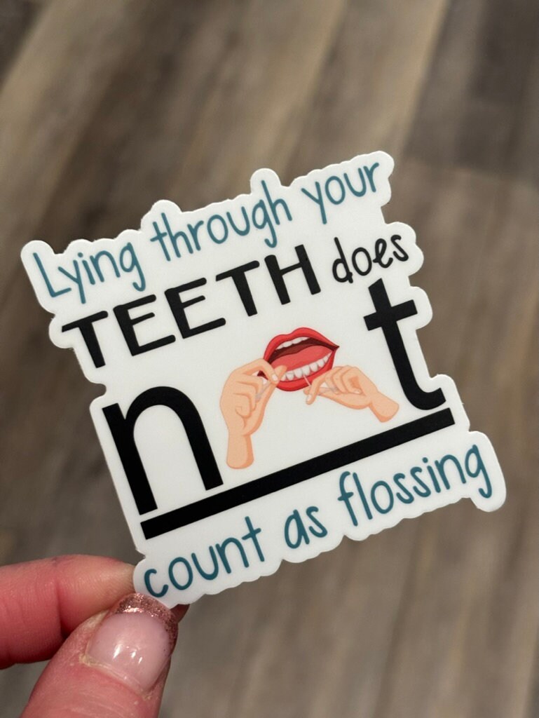 Funny dental sticker from Teeth Obsessed featuring the phrase "Lying Isn't Flossing," perfect as a dental gift or decoration.
