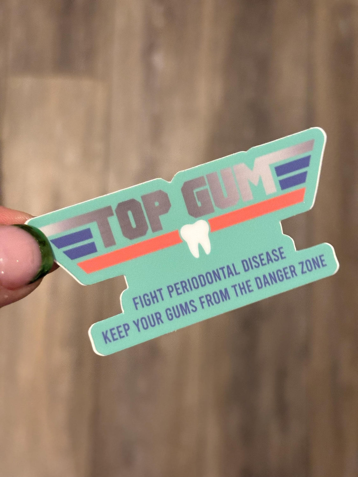 Top Gum Dental Sticker from Teeth Obsessed featuring a fun, colorful tooth design on a transparent background.