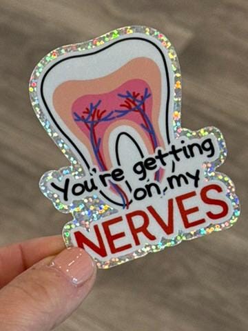 Glitter dental sticker from Teeth Obsessed with the phrase "You're Getting On My Nerves" featuring a fun, quirky design.