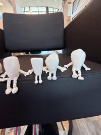 Teeth Obsessed Flossy Friends™ Anterior doll, a colorful dental-themed figure representing the front teeth in a playful design.