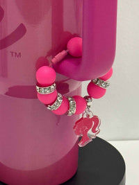 Pink dental team Stanley charm accessory on a teeth-themed tumbler handle for Teeth Obsessed drinkware.