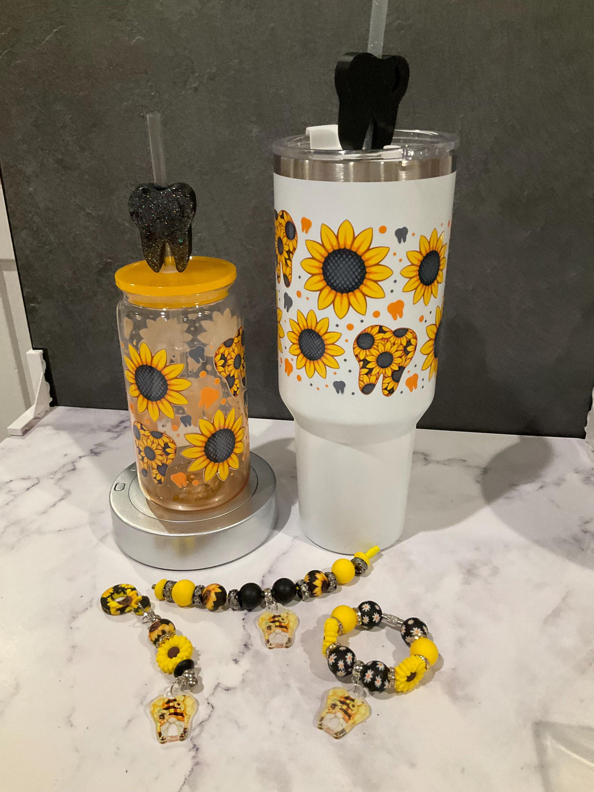 Sunflower Tooth Glass Tumbler by Teeth Obsessed, dental hygienist gift drinkware with a charming tooth design and sunflower decoration.